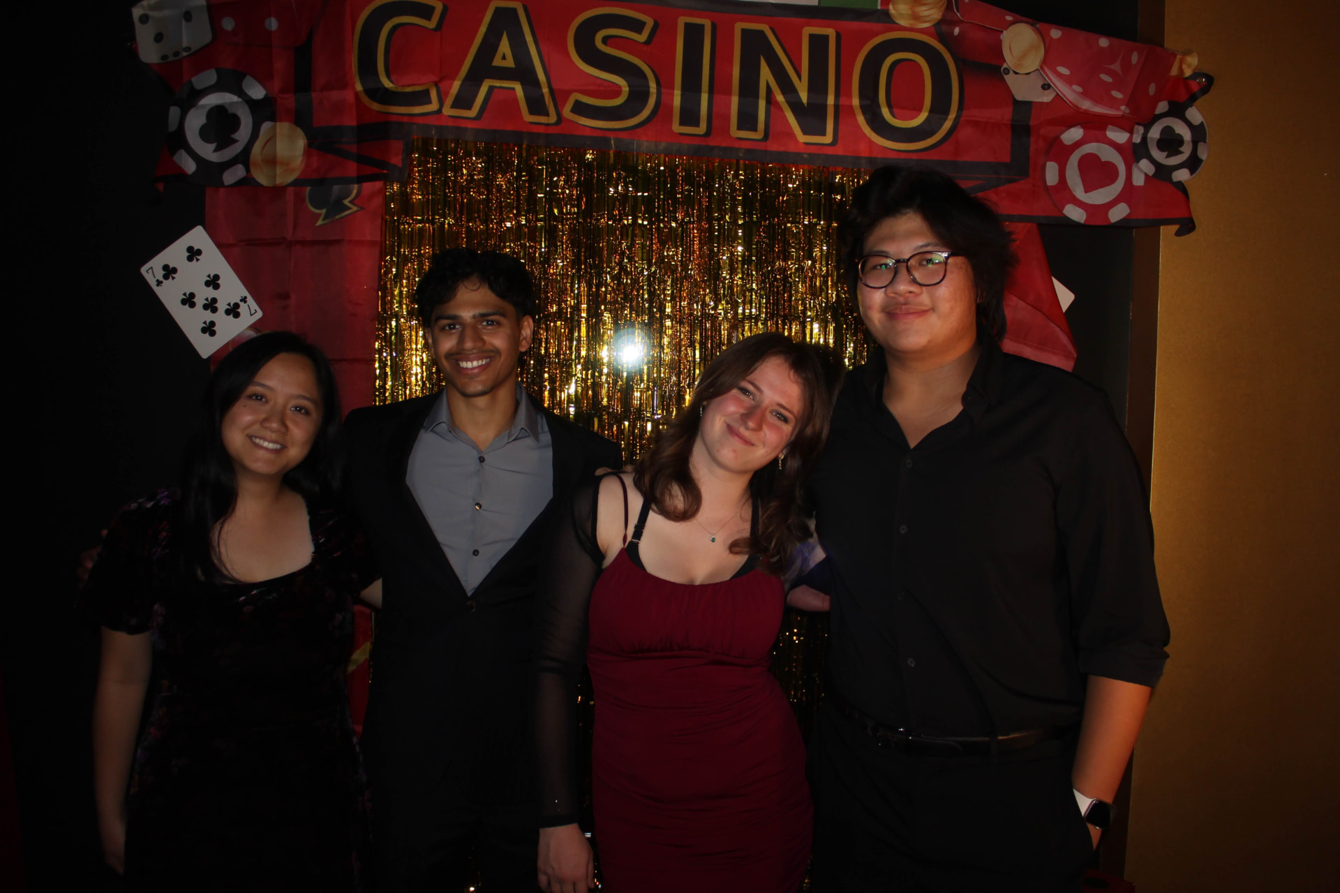 Four chapter members at a casino-themed social