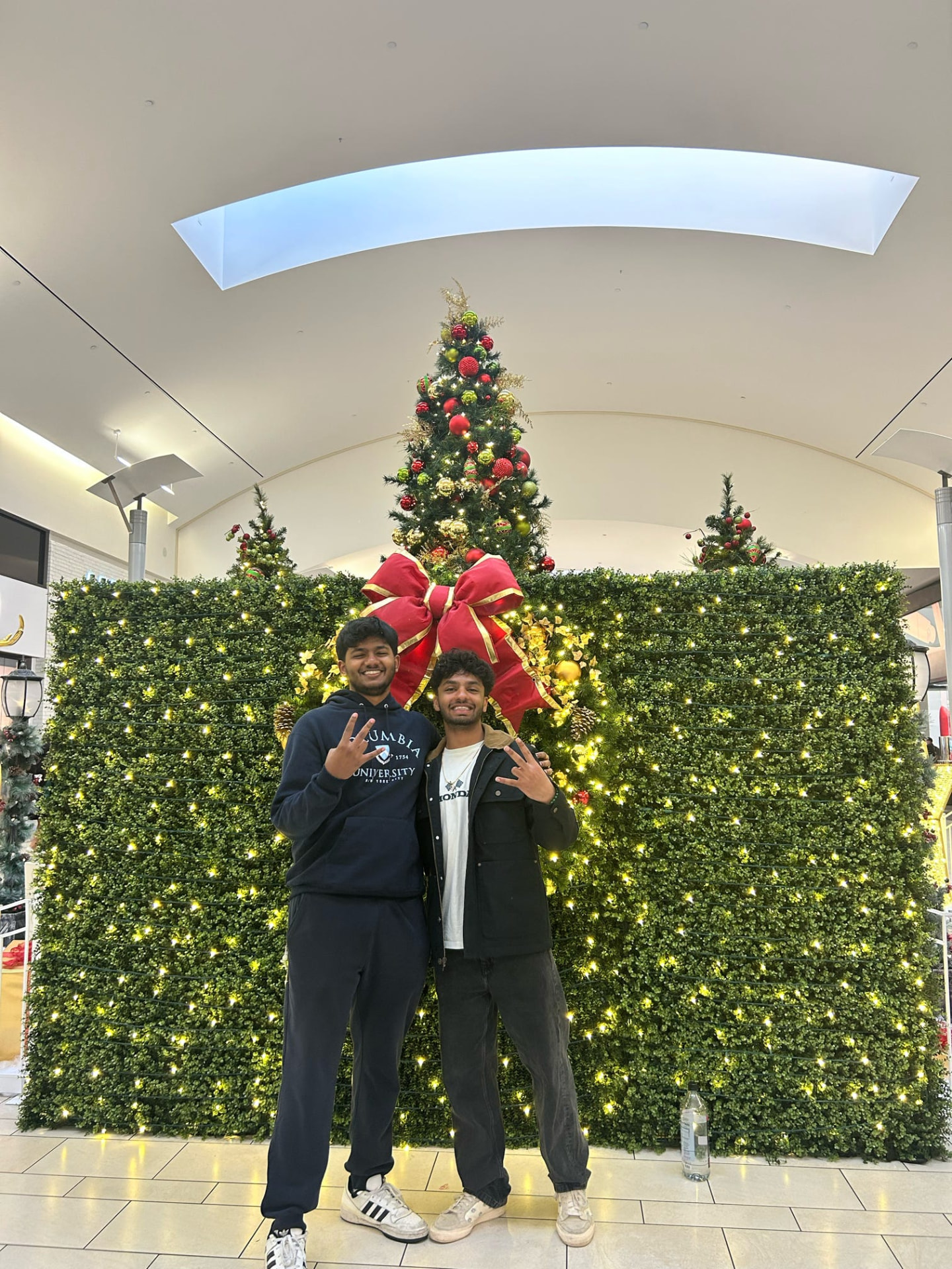 Two chapter members in front of holiday decorations
