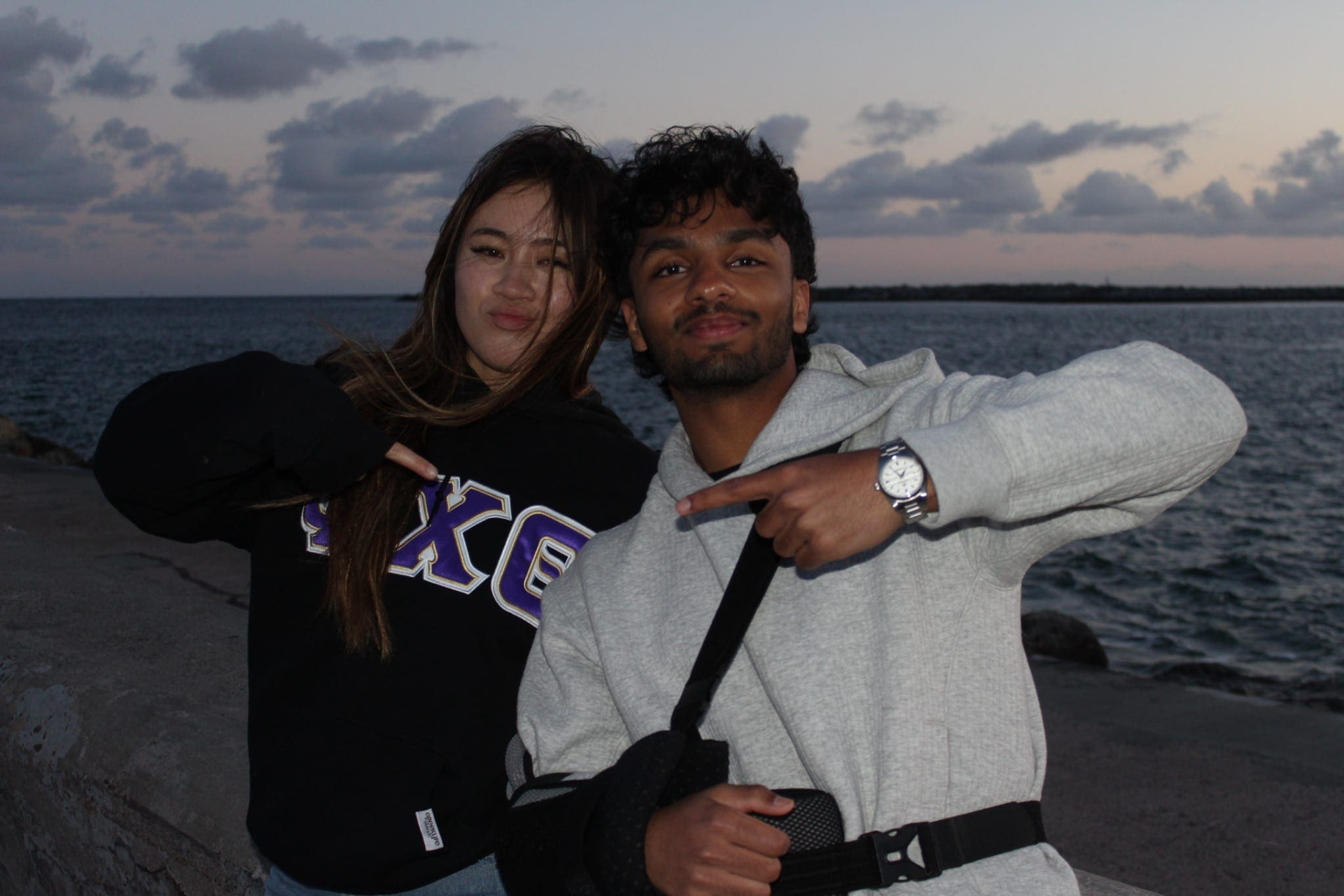 Two chapter members together beside the water