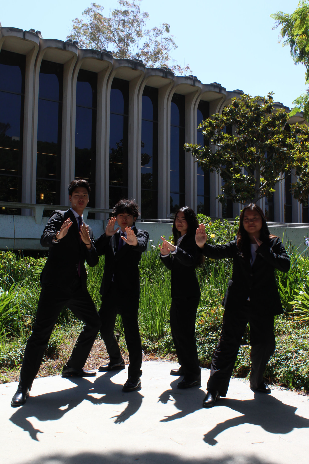 Four chapter members posing together on campus