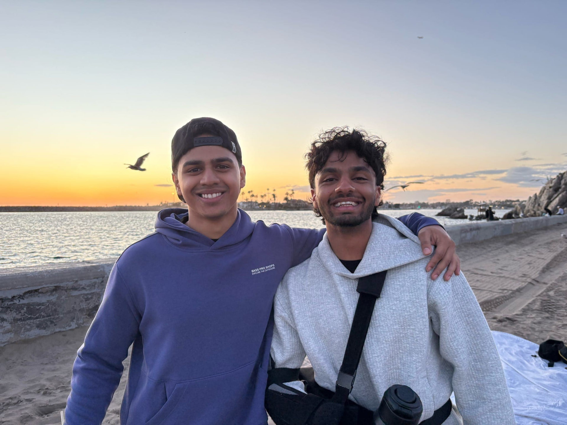Two chapter members together by the waterfront at sunset