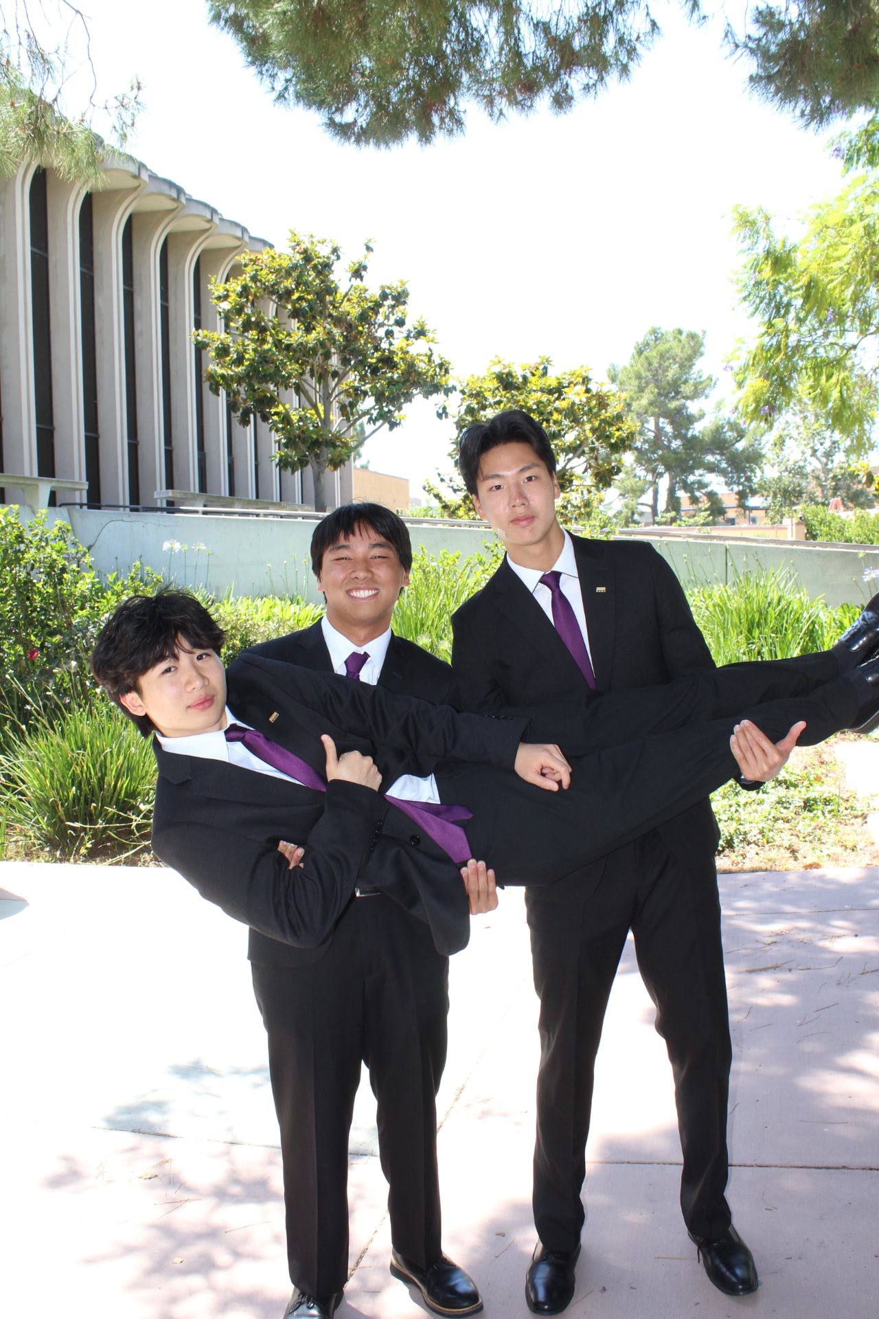 Chapter brothers posing in professional attire on campus