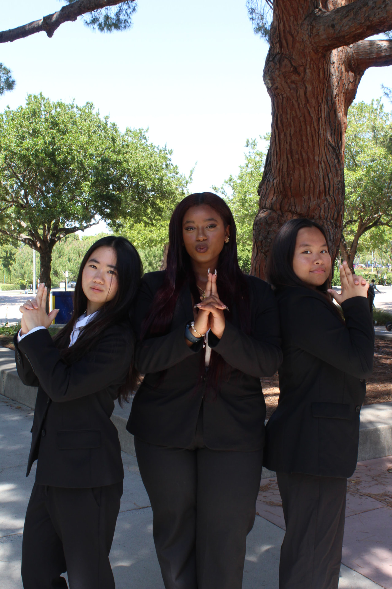 Three chapter members posing in professional attire