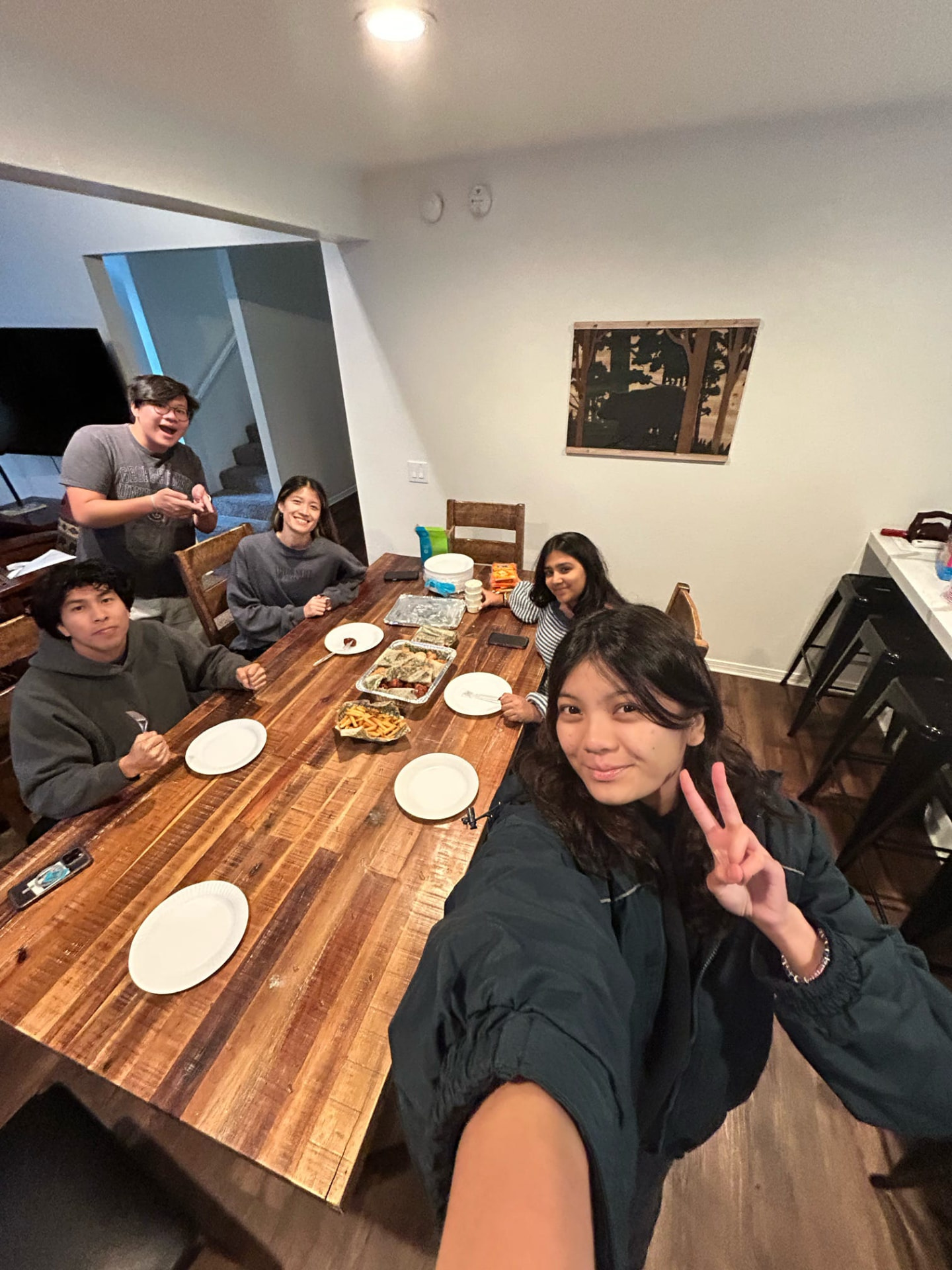 Chapter members sharing a selfie around the dinner table on a retreat