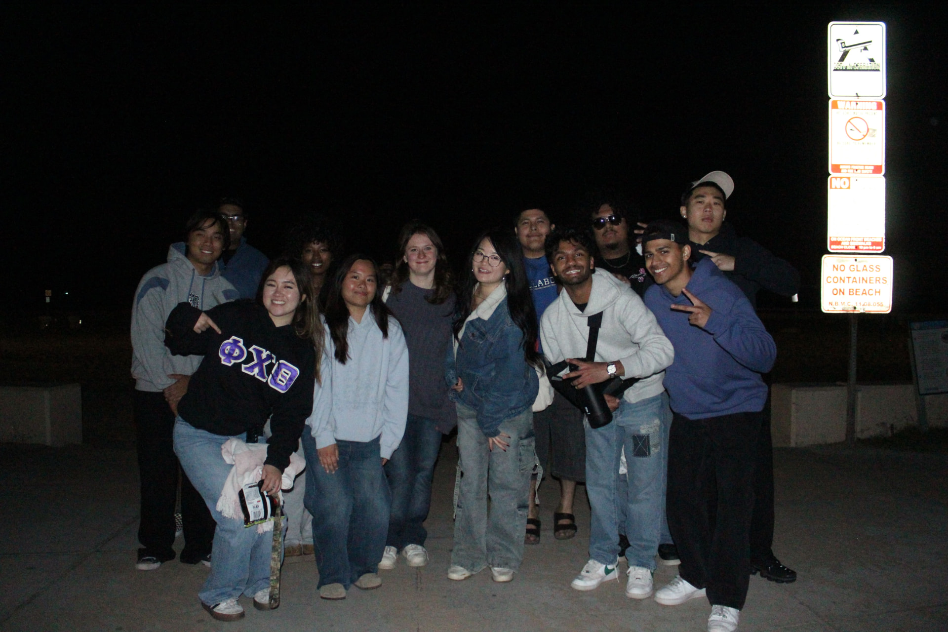 Chapter members together at the beach after sunset